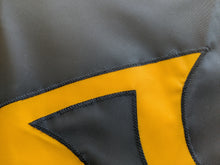 Load image into Gallery viewer, Close-up of black, handsewn Iowa Hawkeyes logo on gold university of iowa applique flag
