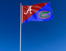 Load image into Gallery viewer, Red and Blue Alabama Florida House Divided Flag with two metal grommets attached to flagpole waving in the wind
