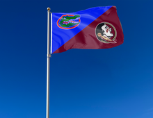 Load image into Gallery viewer, blue and maroon house divided Florida FSU Game Time Flag attached to flagpole waving in the wind
