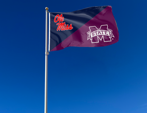 blue and maroon house divided Ole Miss Mississippi State Game flag attached to flagpole waving in the wind