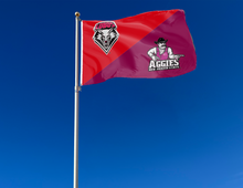 Load image into Gallery viewer, red and maroon New Mexico Lobos New Mexico Aggies House Divided Flag attached to flagpole waving in the wind
