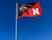 Load image into Gallery viewer, black and red Ohio State Nebraska house divided flag attached to flagpole waving in the wind
