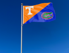 Load image into Gallery viewer, orange and blue Tennessee Florida House Divided Flag attached to flagpole waving in the wind

