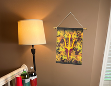 Load image into Gallery viewer, ASU Garden Flag with pitchfork logo and flames background hung inside for college dorm decor
