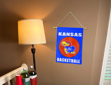 Load image into Gallery viewer, kansas basketball garden flag hung on banner pole next to a lamp and drinks inside
