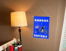 Load image into Gallery viewer, kansas football garden flag hung on banner pole next to a lamp and drinks
