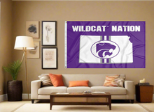 Load image into Gallery viewer, Purple 3x5 foot wide Kansas State University flag with Wildcat Nation logo and two metal grommets covering the tan wall of a well-lit room
