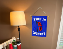 Load image into Gallery viewer, this is tulsa country garden flag hung inside a college dorm for decor
