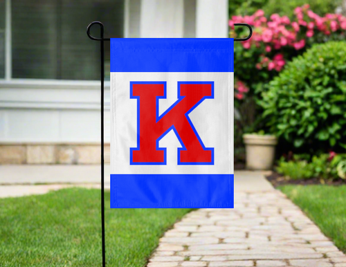 university of kansas garden flag with three panel blue with red K logo outside on garden flag stand