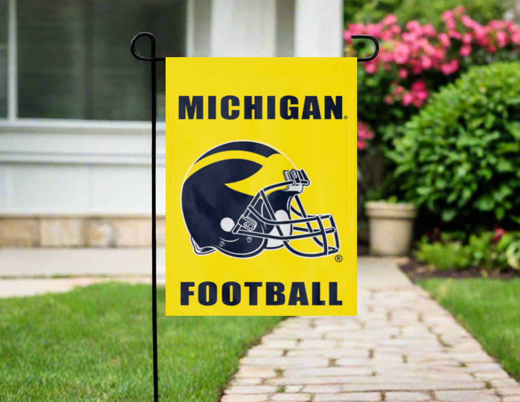 gold Michigan football logo garden flag hung on a garden flag stand outside