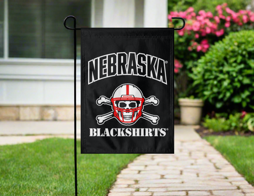 black Nebraska Blackshirts garden flag hung outside from a stand
