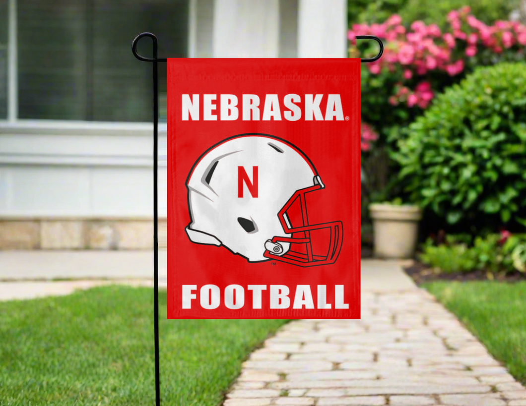 red nebraska football garden flag hung outside from stand