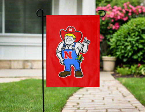 Nebraska Huskers garden flag with Herbie Husker logo hanging on garden flag stand outside