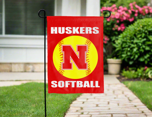 red nebraska softball garden flag hung on garden flag stand outside the home