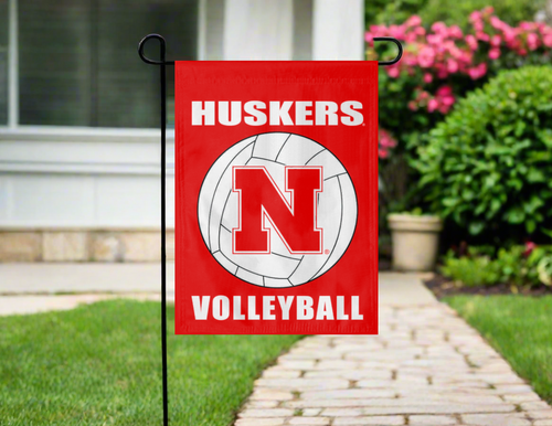 red nebraska volleyball garden flag in front of green grass