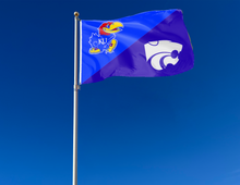 Load image into Gallery viewer, blue and purple Kansas Kansas State House Divided Flag with two metal grommets attached to flagpole waving in the wind
