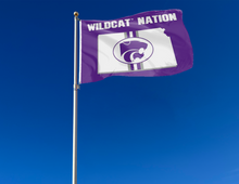 Load image into Gallery viewer, Purple 3x5 foot wide Kansas State University flag with Wildcat Nation logo and two metal grommets attached to flagpole waving in the wind
