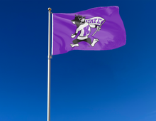 Load image into Gallery viewer, Purple 3x5 foot wide Kansas State University Flag with Willie the Wildcat mascot logo and two metal grommets attached to flagpole waving in the wind
