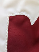 Load image into Gallery viewer, Close-up of the Alabama University A logo hand-sewn onto an applique flag with white zig zag technique

