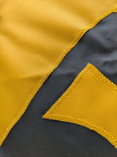 Load image into Gallery viewer, Close-up of a section of a yellow and black University of Iowa National Applique flag, showing the detailed stitching and fabric texture.
