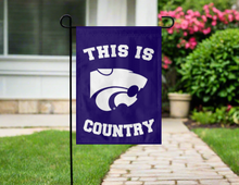 Load image into Gallery viewer, purple kansas state university garden flag with this is country logo hung outside on garden flag stand

