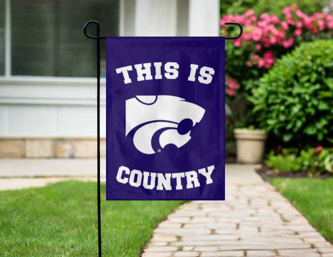purple kansas state university garden flag with this is country logo hung outside on garden flag stand