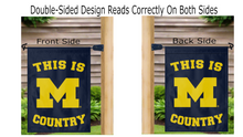 Load image into Gallery viewer, Blue University of Michigan Garden flag with this is Michigan Country logo hung from both sides on a mailbox flagpole
