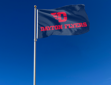 Load image into Gallery viewer, Dark Blue 3x5 foot wide University of Dayton Flyers Blue 3x5 Flag with red D Dayton Flyers logo and two metal grommets attached to flagpole waving in the wind
