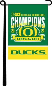 Green 13x18 inch long University of Oregon BIG Ten Football Championship 2024 Champions Garden Flag hanging on black garden flag stand