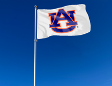 Load image into Gallery viewer, White 3x5 foot wide Auburn Flag with blue and orange AU Logo and Two Metal Grommets attached to flagpole waving in the wind
