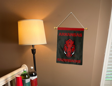 Load image into Gallery viewer, back side of arkansas razorbacks garden flag hung inside for dorm decor
