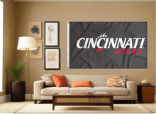 Load image into Gallery viewer, indoor display of black university of cincinnati bearcats flag for fan cave decor
