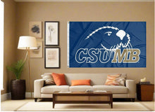 Load image into Gallery viewer, indoor display of blue csumb otters flag for man cave decor
