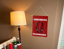 Load image into Gallery viewer, front side of arkansas razorbacks garden flag hung inside for dorm decor
