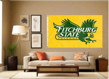 Load image into Gallery viewer, indoor display of gold fitchburg state university falcons flag for man cave decor
