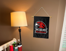 Load image into Gallery viewer, miami redhawks garden flag hung inside a college dorm for dorm decor
