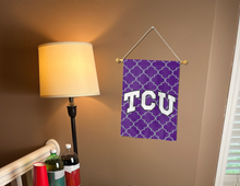 Load image into Gallery viewer, purple tcu garden flag with grey pattern background hung inside for college dorm decor
