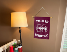 Load image into Gallery viewer, this is mississippi state country garden flag hung indoors for college dorm decor
