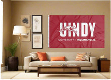Load image into Gallery viewer, indoor display of red university of indianapolis flag with uindy logo for man cave decor
