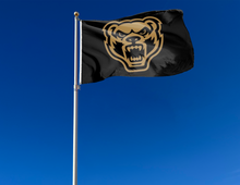 Load image into Gallery viewer, outdoor display of black oakland university grizzlies flag for tailgate decor 
