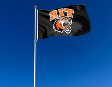 Load image into Gallery viewer, outdoor display of black rochester institute of technology flag with rit logo for tailgate decor
