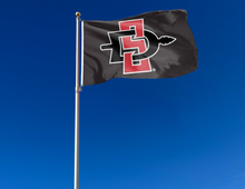 Load image into Gallery viewer, outdoor display of black san diego state university aztecs flag for tailgate decor
