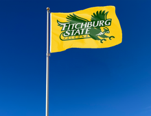 Load image into Gallery viewer, outdoor display of gold fitchburg state university falcons flag for tailgate decor
