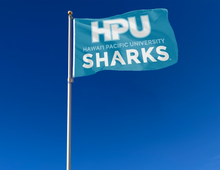 Load image into Gallery viewer, outdoor display of blue hawaii pacific university flag with hpu sharks logo for tailgate decor
