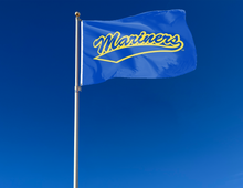 Load image into Gallery viewer, outdoor display of blue maine maritime academy flag with mariners logo for tailgate decor

