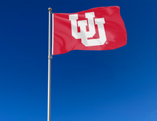 Load image into Gallery viewer, outdoor display of red university of utah flag with interlock uu logo for tailgate decor
