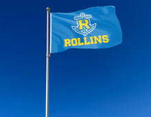 Load image into Gallery viewer, outdoor display of blue rollins college tars flag for tailgate decor

