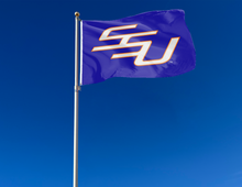 Load image into Gallery viewer, outdoor display of blue savannah state university flag with ssu logo for tailgate decor
