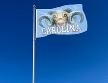 Load image into Gallery viewer, outdoor display of university of north carolina flag with realistic ram logo for tailgate decor
