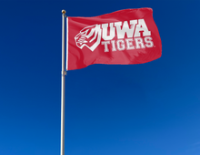Load image into Gallery viewer, outdoor display of red university of west alabama tigers flag with uwa logo for tailgate decor
